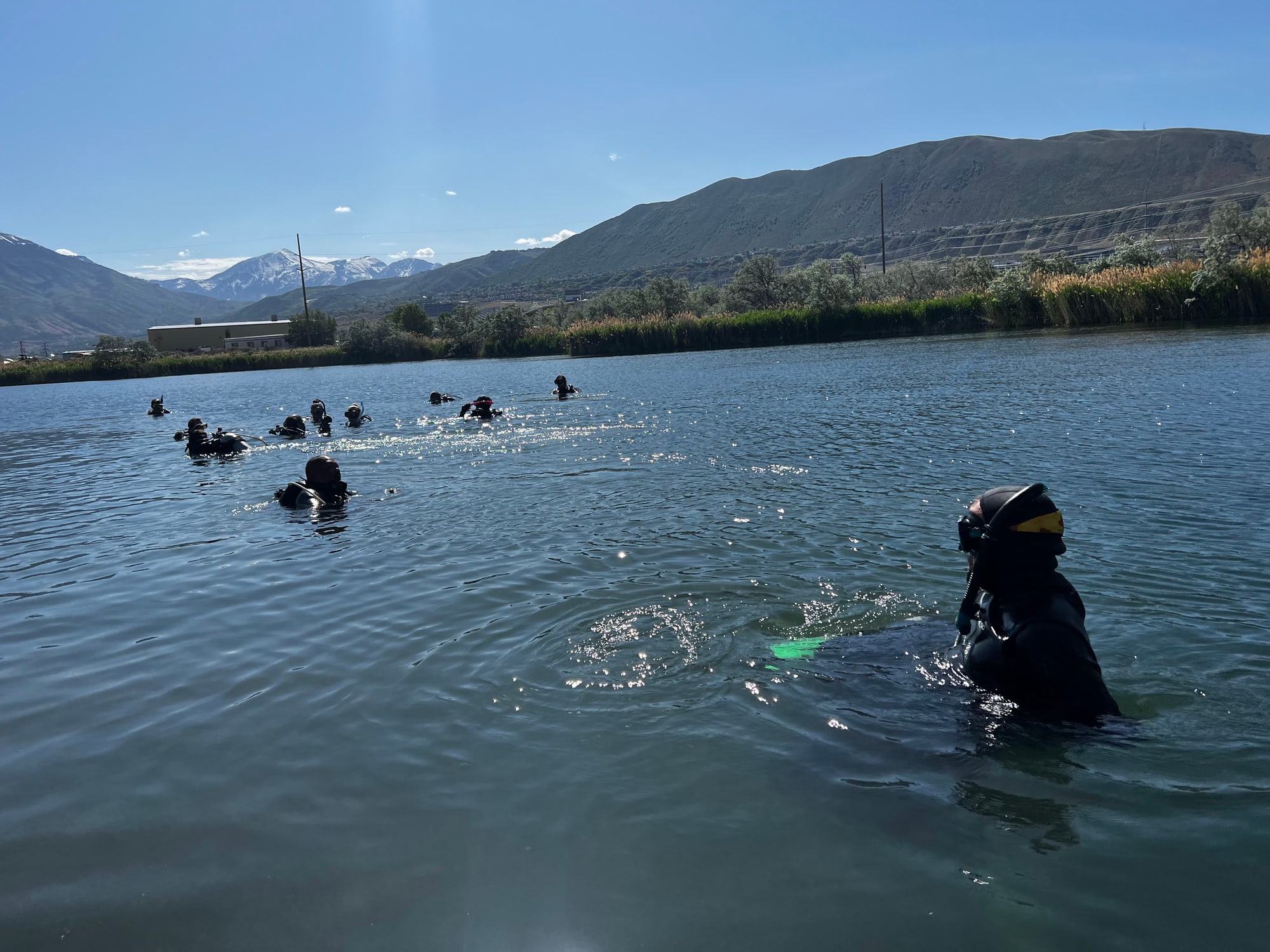 A group of divers exploring Mountain Point Lake beneath Point of the Mountain