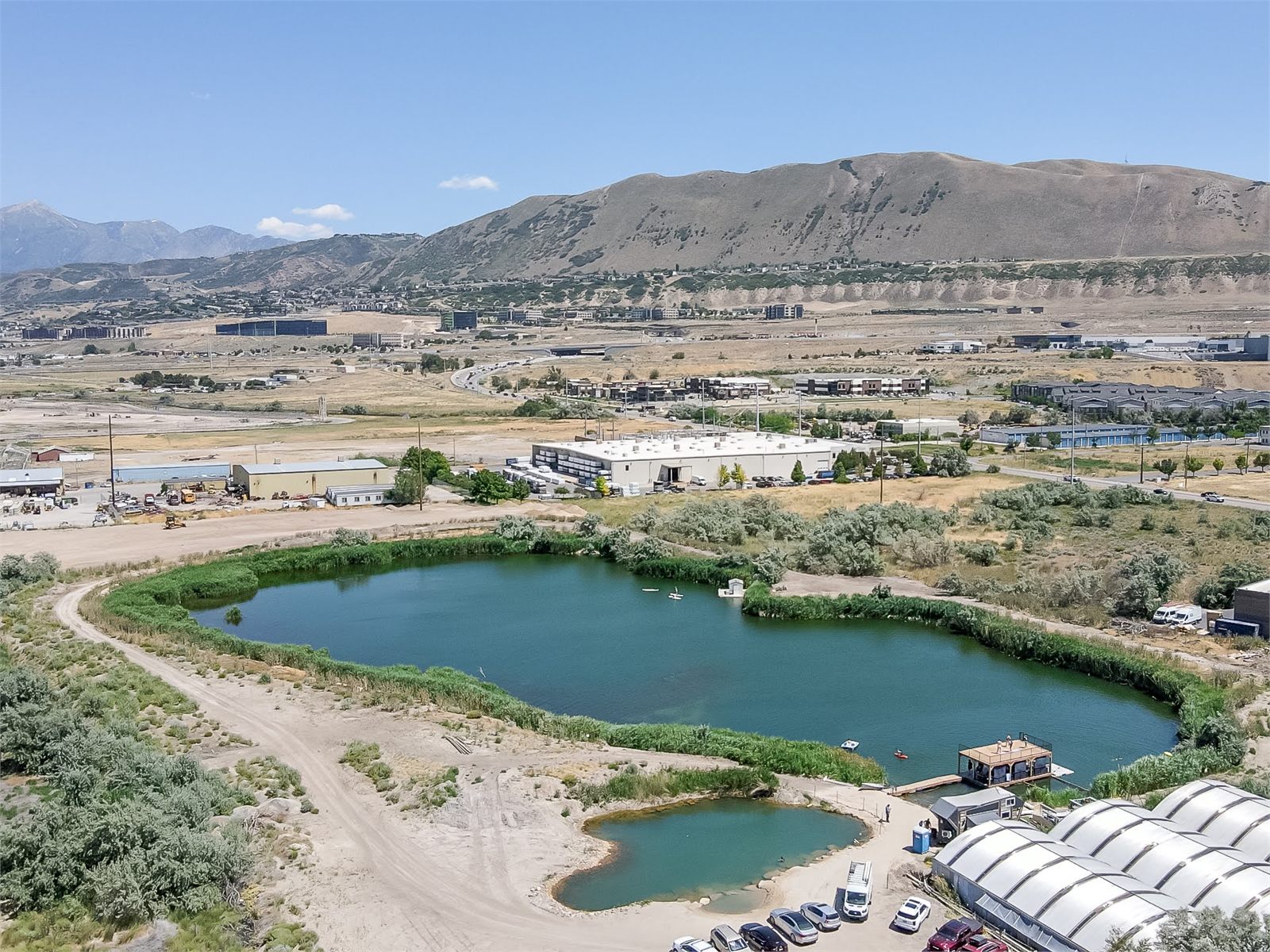 Aerial view of the western lake, fish farm, and greenhouses beneath Utah's Point of the Mountain