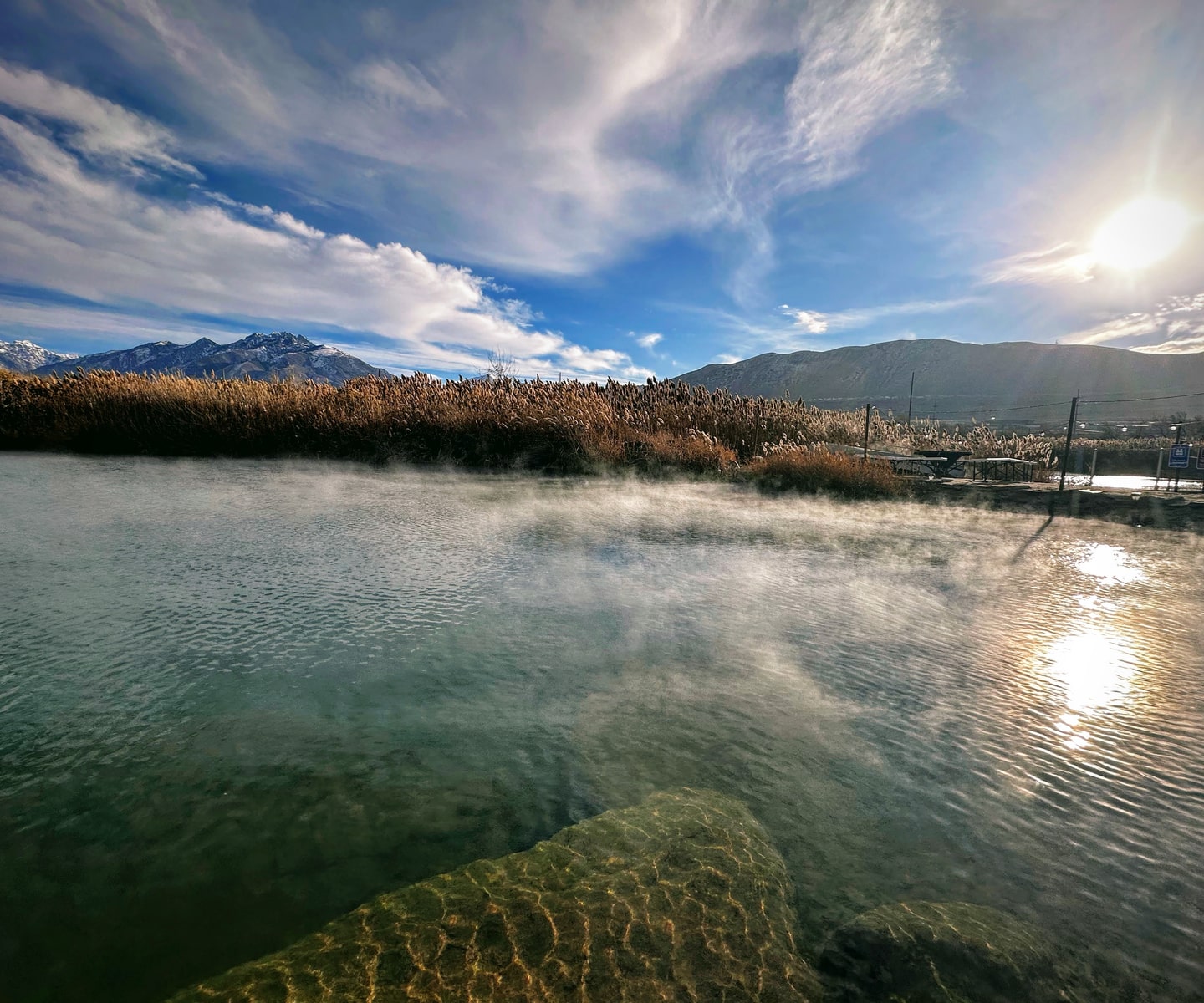 Steam rising from warm spring water beneath Point of the Mountain